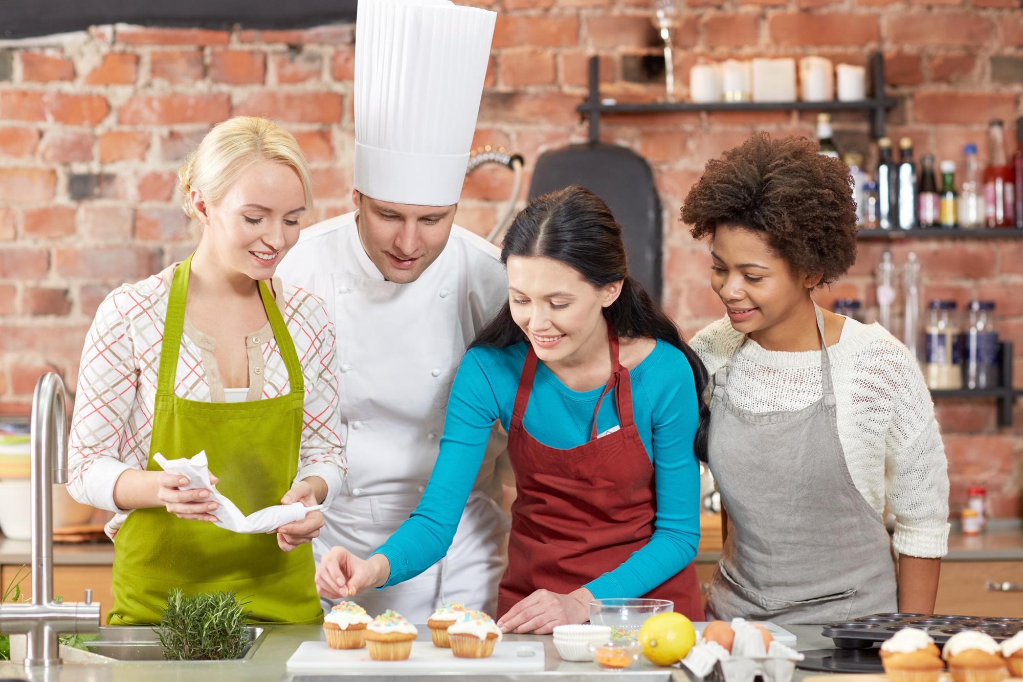 Group cooking session in a bright kitchen