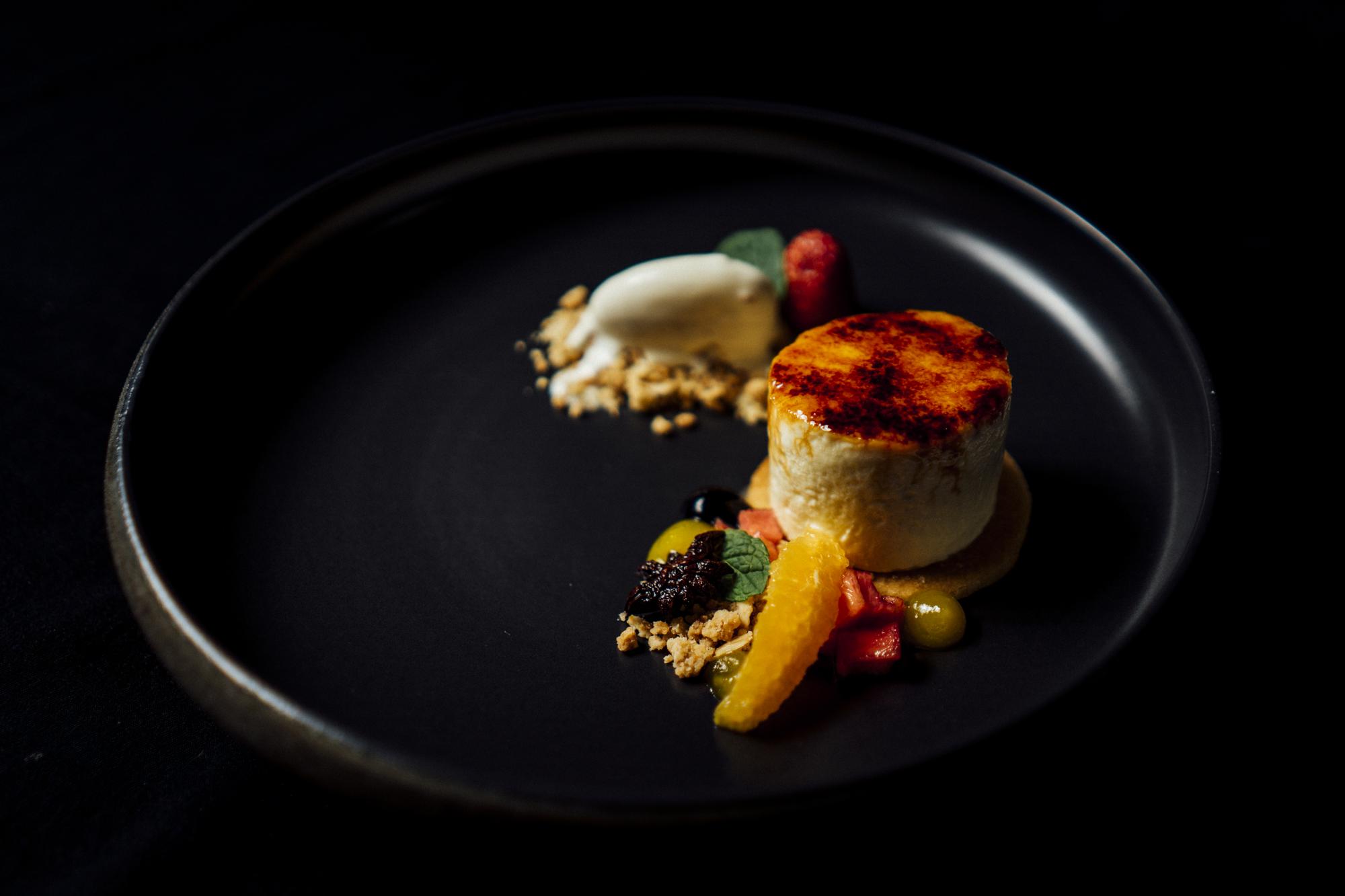 Plated gourmet main course on a dark plate